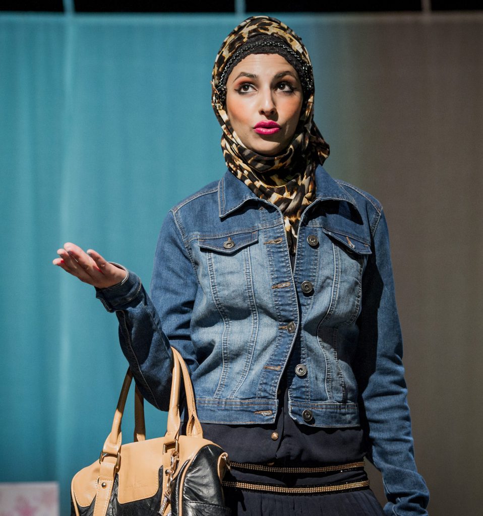 woman with headscarf on theatre set