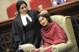 a barrister comforting her client