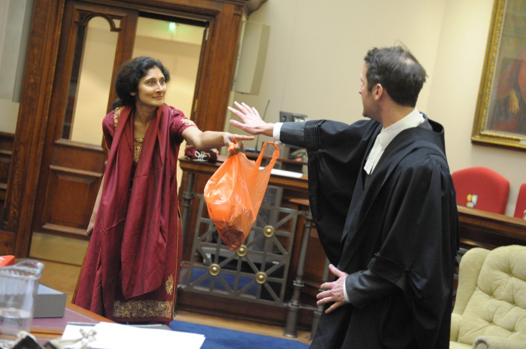 a woman pointing angrily at a barrister