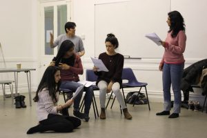 writer with scripts in workshop with actors