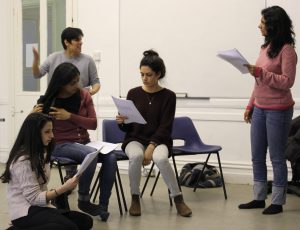 Group of actors reading from script