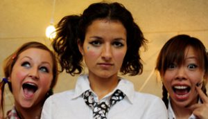 Three female actors looking at camera